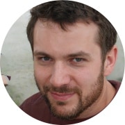 A circular portrait photograph of Derek H.