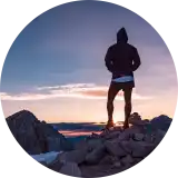 A circular portrait photograph of team member Joel.